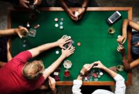 Diverse group playing poker and socialising