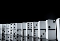 White dominoes in the dark close up