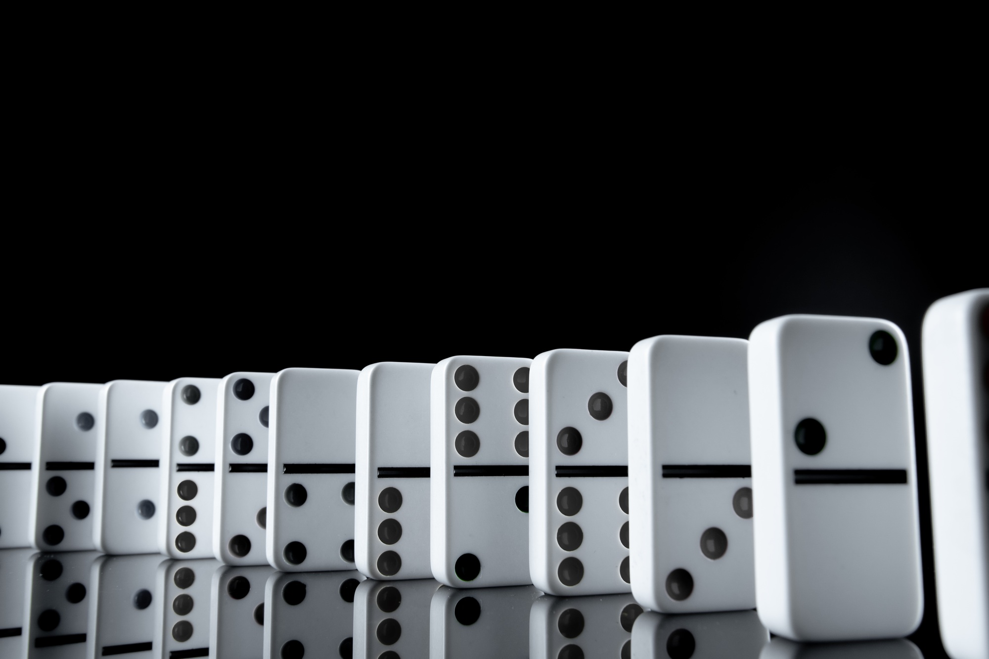 White dominoes in the dark close up