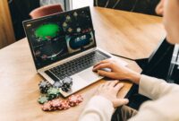 Young man play online poker in laptop.